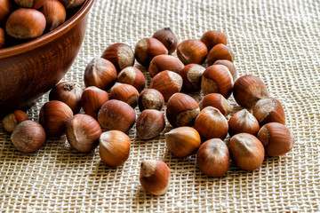 A lot of hazelnut on a wooden background. view from above. Background of hazelnut nuts.