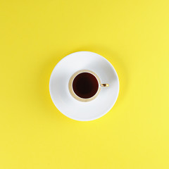 White Cup with coffee on yellow background