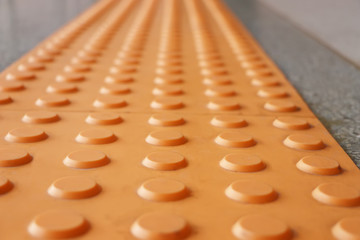 Tactile paving  is a system of textured ground surface indicator found on footpaths, stairs and train station platforms to assist pedestrians who are visually impaired