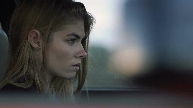 The girl is sad for driving a car, a model of a hipster in the car, Melancholy