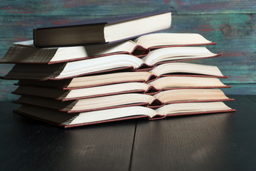 Open book hardback on Stack books