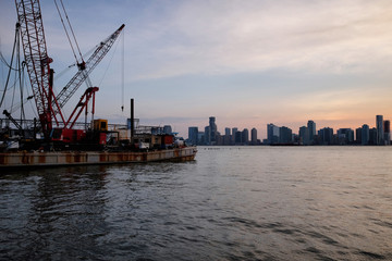 New York City skyline with urban skyscrapers over Hudson River. Manhattan panorama from Chelsea district. Pier waterfront view to the harbor at sunset.


