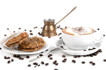 Cup of coffee and biscuit isolated on the white background, close-up, shallow depth of field.