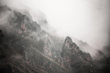 Fototapeta premium High mountains and rocks in the clouds