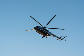 helicopter in the air against the blue sky
