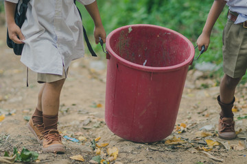 Students help to remove rubbish from the classroom to pile waste