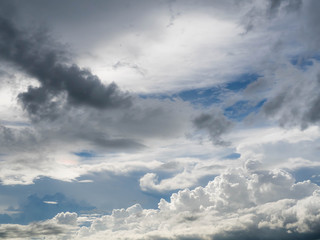 Dark blue grey layered clouds sky cover sun before raining.