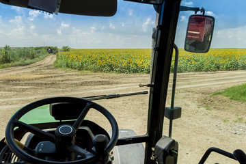 tractor interior and sunflower field
