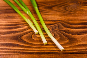 Young green onion on a wooden table
