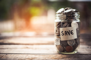 Coins in glass jar for money saving Investment and finance concept