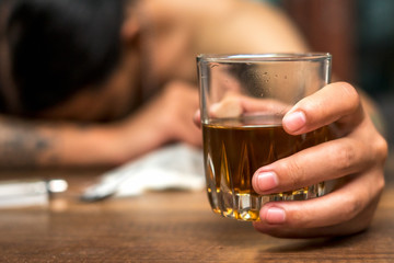 Drunk man asleep at a table. Alcoholism