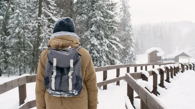 Young person hiking in snowy park
