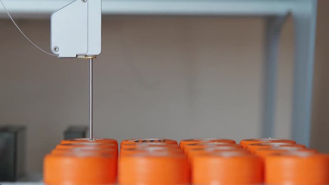 In the medical laboratory close-up robot performs the procedure of artificial fertilization of eggs with a needle