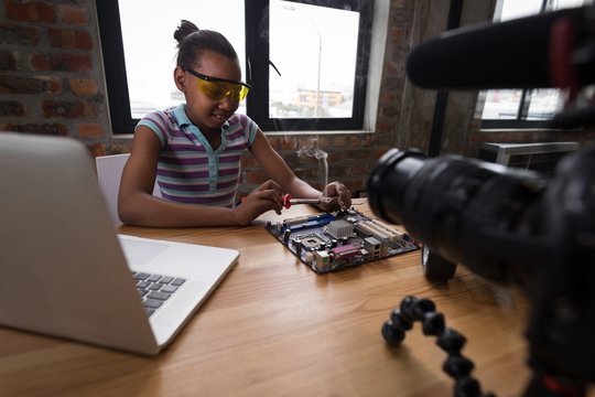Teenage blogger soldering a circuit board