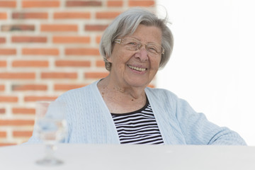 Senior Woman Sitting in Front of Her House 6