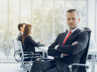 Portrait smart european businessman front of teamwork during meeting conference in company's office