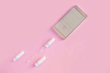 Menstrual tampon  on a pink background. Menstruation time. Hygiene and protection. Pasterl colors.

