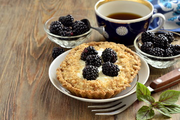 Tartlets with cream and blackberries, copy space
