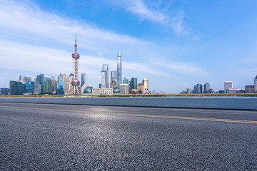 empty asphalt road with city skyline