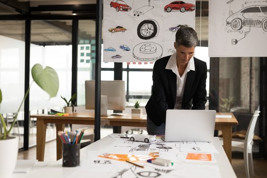 Businesswoman using laptop in office
