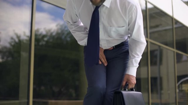 Middle-aged manager feeling strong pain, prostatitis, male genital disease