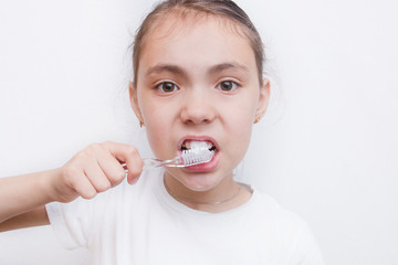 Girl brushing cleaning teeth. Girl with toothbrush. Oral hygiene, isolated