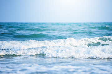 Naklejka na ściany i meble Soft wave of blue ocean on sandy beach background,ocean waves,storm,beautiful background,close-up