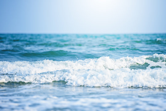 Fototapeta Soft wave of blue ocean on sandy beach background,ocean waves,storm,beautiful background,close-up