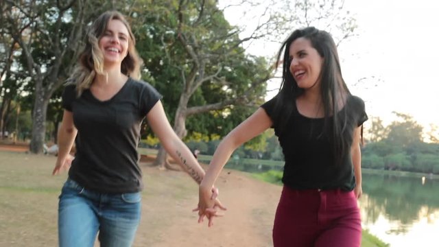 LGBT couple runing holding hands