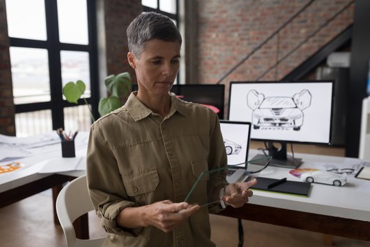 Businesswoman using glass digital tablet