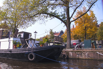 Fototapeta premium The canal in Amsterdam. Blue sky and boat. in the city. Free space for text