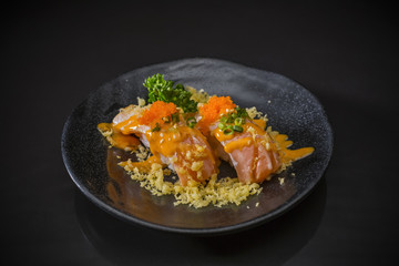 Aburi Miso Salmon Nigiri, Burned Salmon Sushi and topped with Shrimp Eggs, tempura and Miso sauce, traditional Japanese food on ceramic dish, Japanese food style, selective focus