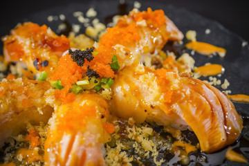 Salmon Nigiri, Sushi salmon burned and topped with Shrimp Eggs and Tempura, Japanese food style, Japanese Food menu, selective focus