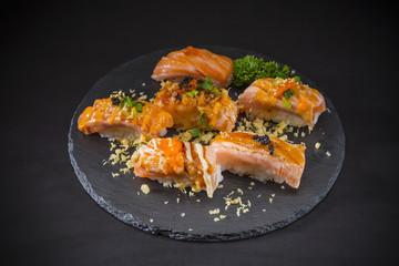 Salmon Nigiri, Sushi salmon burned and topped with Shrimp Eggs and Tempura, traditional Japanese food on ceramic dish, Japanese food, Japanese Food menu, selective focus