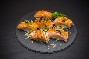 Salmon Nigiri, Sushi salmon burned and topped with Shrimp Eggs and Tempura, traditional Japanese food on ceramic dish, Japanese food, Japanese Food menu, selective focus
