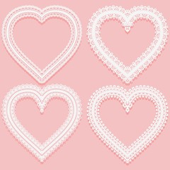 Collection of white Lacy frames in the shape of heart. Openwork vintage elements isolated on a pink background.