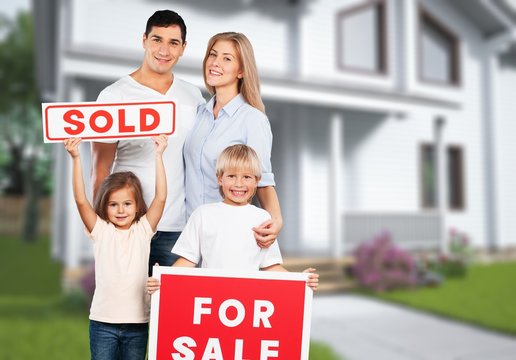 Happy Family With For Sale Sign