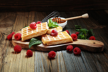 Traditional belgian waffles with fresh mint, sugar and raspberries.