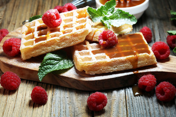 Traditional belgian waffles with fresh mint, sugar and raspberries.