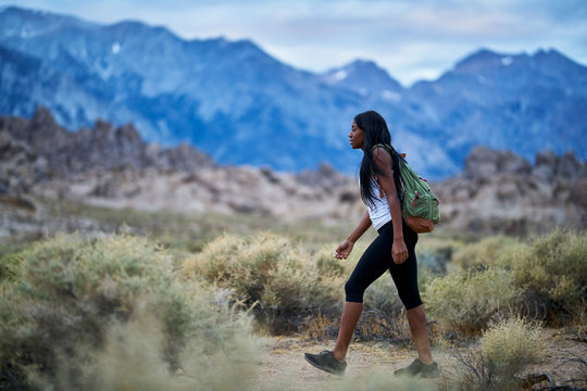 fit african american woman hiking through alabama hills park in california