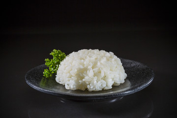 Japanese traditional steamed white rice, steamed rice on black background, Japanese food, Japanese dish