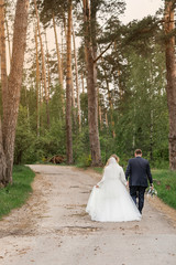 Wedding day. Newlyweds in the forest. Just married