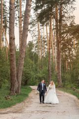 Fototapeta premium Wedding day. Newlyweds in the forest. Just married