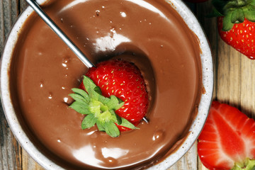 Fondue with Melting chocolate or melted chocolate and strawberry.