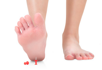 front view of woman feet stepping on the red push pin, unforeseen concept, Isolated on white...