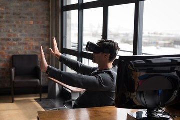 Male executive using virtual reality headset