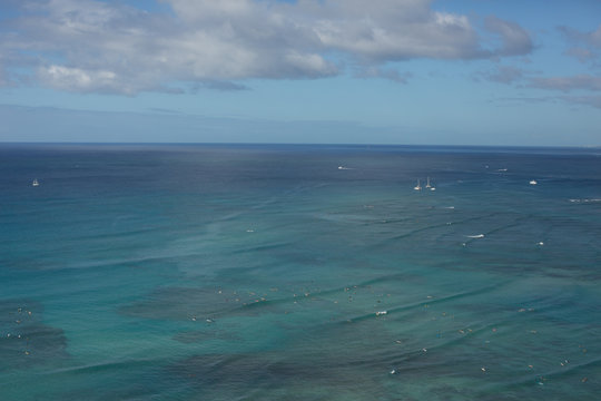 Boats and birds floating in ocean near Oahu, Hawaii