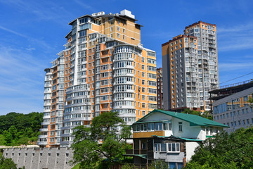 Vladivostok, Russia. 
Old house on the background of the residential complex