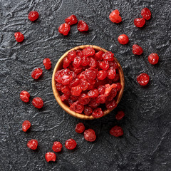 Dried red cherries on a black background