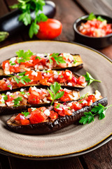Baked eggplants with tomatoes, onion and garlic